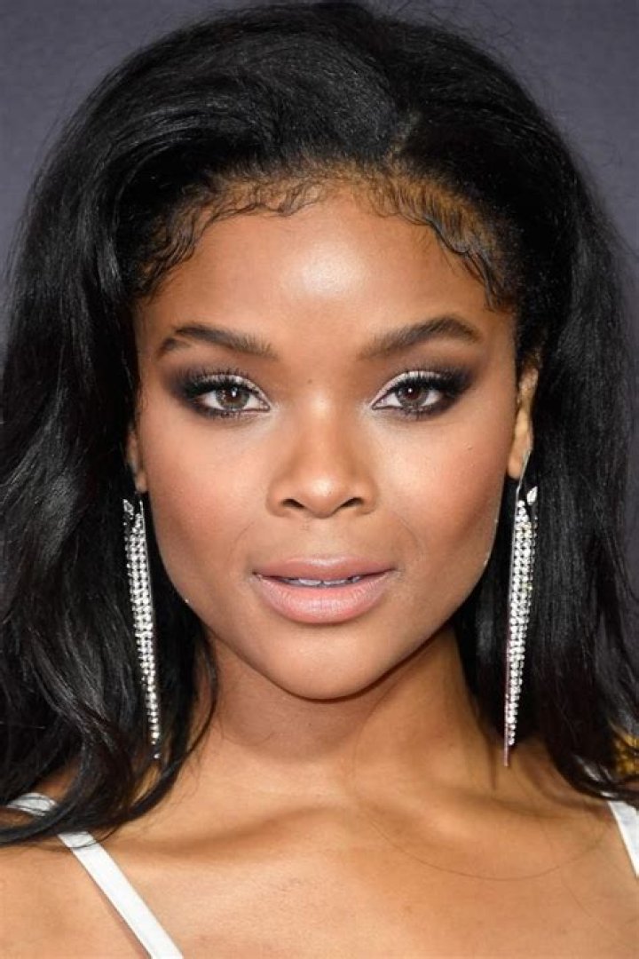 Ajiona Alexus carrying a water bottle