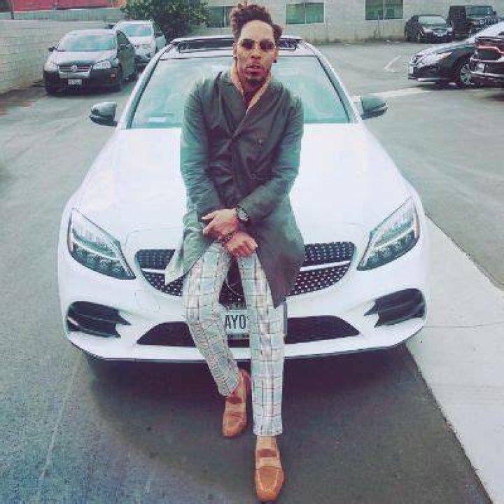 Deitrick Haddon posing with his car