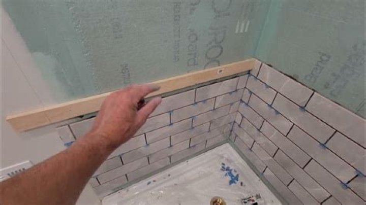 How do you tile an uneven shower wall?