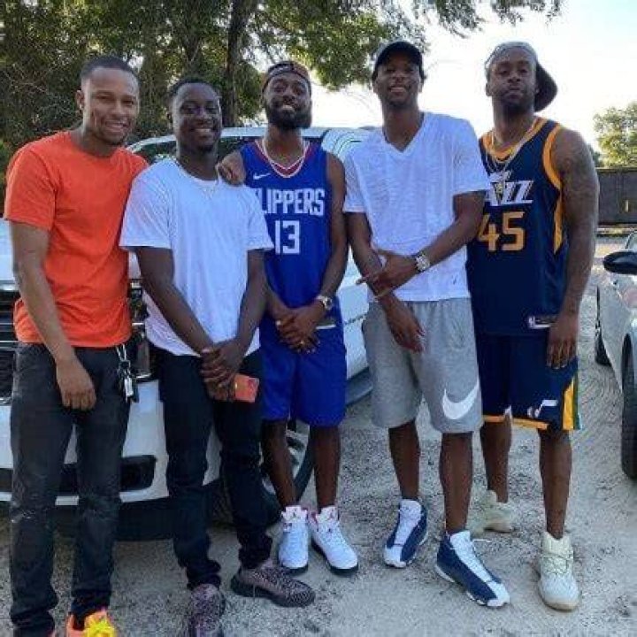 Kountry Wayne wearing blue basket ball jersey. 