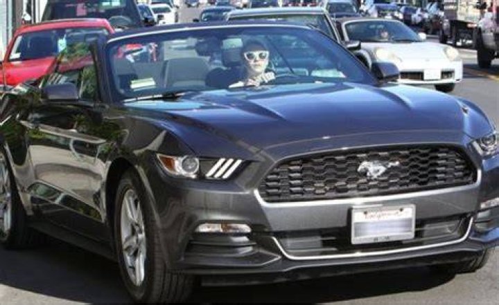 Roberts driving her Ford Mustang Convertible