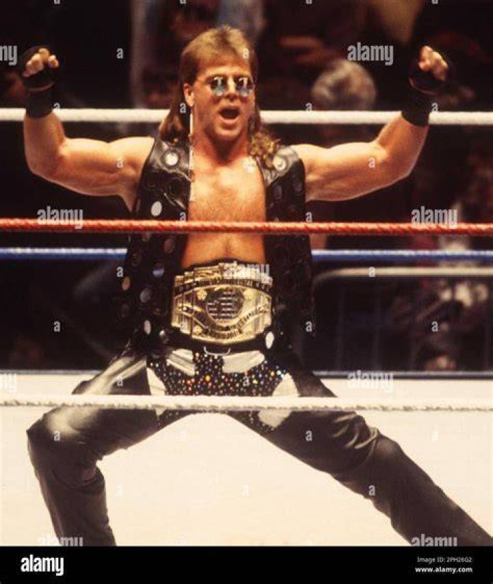 Shawn Michaels is wearing a cowboy hat as he looks onto the crowd.